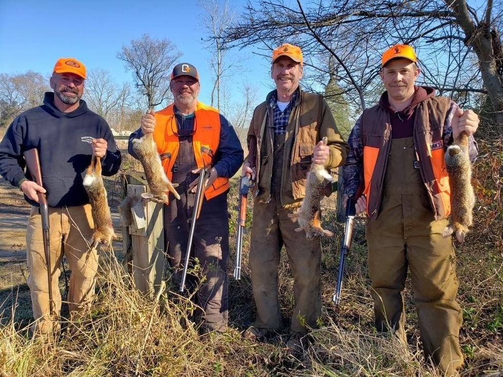 Rabbit hunters with Monquin Creek Outdoors holding the day's cottontails
